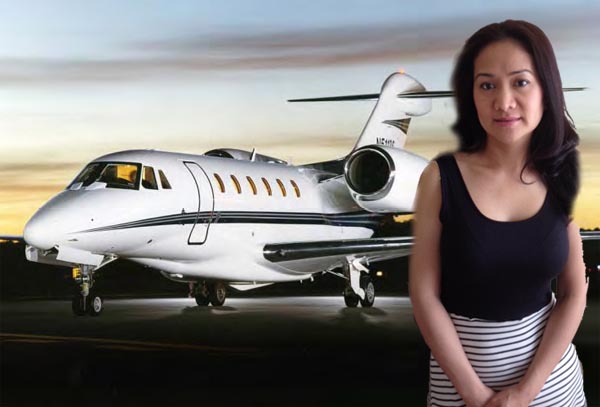 Rich woman standing in front of Private Jet